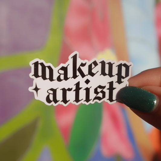 Sticker with 'makeup artist' text held in front of a colorful abstract background