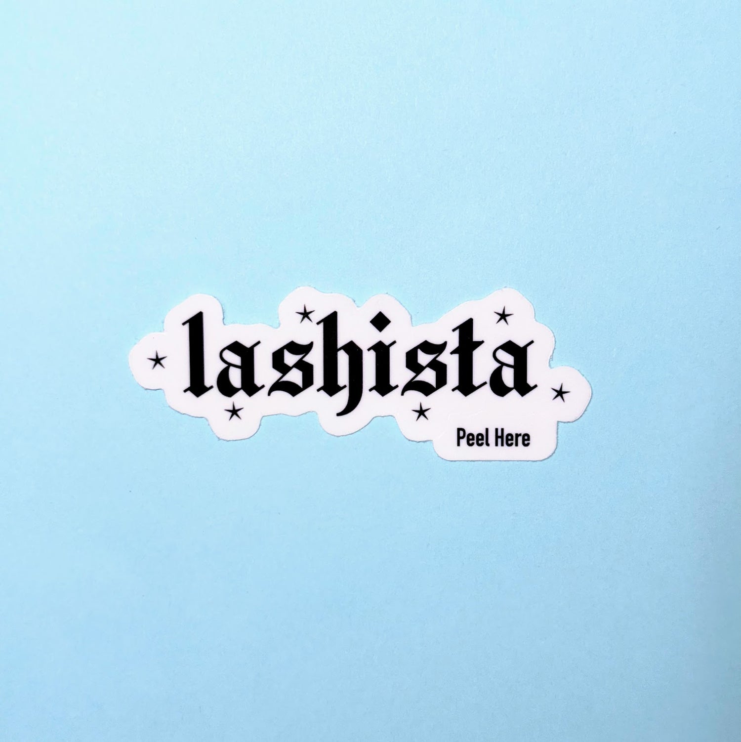 Sticker with 'lashista' text on a light blue background
