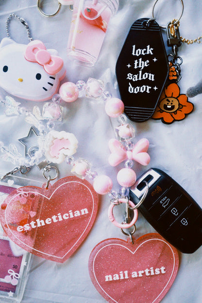 Collection of keychains with various designs and text on a light background